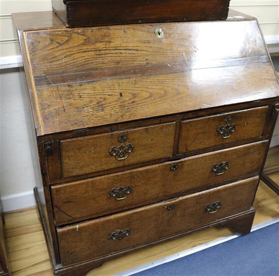 A George III oak bureau, W.102cm